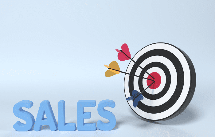 Target board with arrows in the middle next to the word sales 