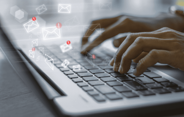 typing an email at laptop 