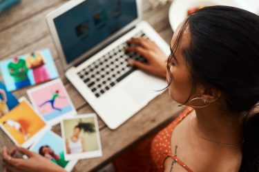 Woman using computer trying to pick the best image for her blog