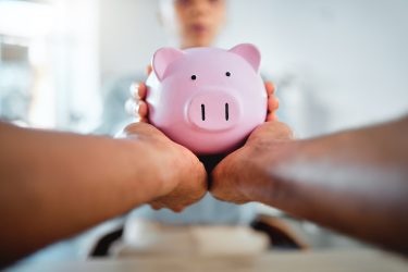 Piggybank, finance and planning savings budget with financial advisor, bank manager and accountant