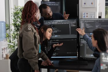 Software programmers analyzing html code and database, brainstorming script ideas to develop new security system. Engineers working with coding language collaborating on group project.
