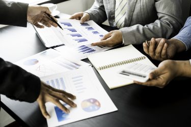 Business team presentation meeting Asian Men Finance Executive discusses meetings to plan work, investment projects, and trading strategy for trading partners. Finance and Accounting